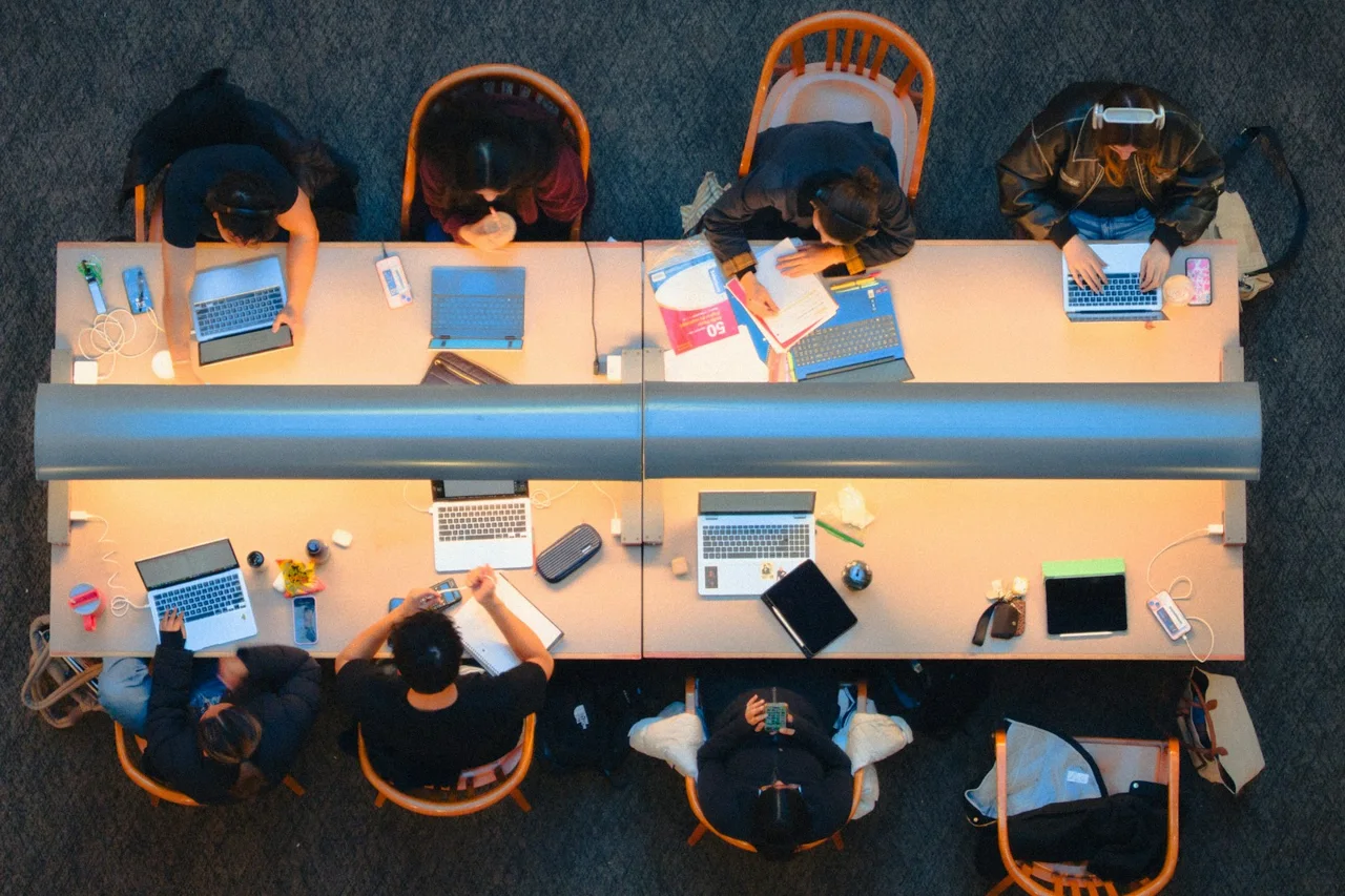 People studying at a shared table in a Kingston, Ontario library